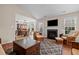 Inviting living room with a fireplace and a view into the dining area at 66 Newbury Dr, Angier, NC 27501