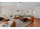 Cozy living room with hardwood floors, ceiling fan, and access to the backyard at 66 Newbury Dr, Angier, NC 27501
