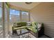 Cozy sunroom featuring bright green furniture and large windows with backyard views at 66 Newbury Dr, Angier, NC 27501