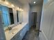 Bathroom boasts double vanity with tile flooring and modern mirrors at 72 E Victory View Ter, Smithfield, NC 27577