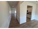 Hallway leading to living spaces, featuring trim and wood-look floors at 72 E Victory View Ter, Smithfield, NC 27577