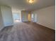 Large carpeted living room area with neutral walls and a ceiling light at 72 E Victory View Ter, Smithfield, NC 27577