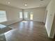 Spacious living room with wood look floors, lots of light, and neutral paint at 72 E Victory View Ter, Smithfield, NC 27577