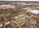 Real estate aerial view of the residential neighborhood surrounded by trees with proximity to commercial areas at 74 Azalea Dr, Roxboro, NC 27573