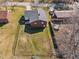 Aerial view showcasing a spacious, fenced backyard, the house, and a patio area at 74 Azalea Dr, Roxboro, NC 27573