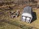 Aerial view of property featuring a shed, firepit, fenced yard, and mature trees at 74 Azalea Dr, Roxboro, NC 27573