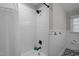 Updated bathroom with subway tile shower, modern fixtures, wainscoting, and patterned tile flooring at 74 Azalea Dr, Roxboro, NC 27573