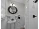 Stylish bathroom features a vanity, round mirror, and tiled shower at 74 Azalea Dr, Roxboro, NC 27573