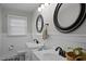 Bathroom featuring dual sinks, stylish fixtures, and neutral walls, plus patterned tile flooring at 74 Azalea Dr, Roxboro, NC 27573