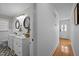 Bathroom featuring double vanities, hexagon tile floor, and a hall leading to the front door at 74 Azalea Dr, Roxboro, NC 27573