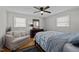 Cozy bedroom with a ceiling fan, dresser, love seat, and stylish patterned bedding at 74 Azalea Dr, Roxboro, NC 27573