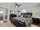 Comfortable bedroom featuring a ceiling fan, dresser, and a well-lit bedside table at 74 Azalea Dr, Roxboro, NC 27573