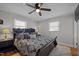 Comfortable bedroom features natural light, neutral walls, a ceiling fan, and inviting bedding at 74 Azalea Dr, Roxboro, NC 27573