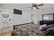 Spacious bedroom featuring a large TV, closet, and patterned bedding at 74 Azalea Dr, Roxboro, NC 27573