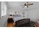 Cozy bedroom with a ceiling fan, closet, and hardwood floors at 74 Azalea Dr, Roxboro, NC 27573