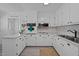 Bright kitchen with white cabinets, modern appliances, and light countertops at 74 Azalea Dr, Roxboro, NC 27573