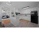 Bright kitchen with white cabinets, modern appliances, and an adjacent living area at 74 Azalea Dr, Roxboro, NC 27573