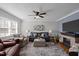 Inviting living room with a fireplace, ceiling fan, and comfortable seating at 74 Azalea Dr, Roxboro, NC 27573