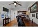 Office boasts hardwood floors, dark wood furniture, natural light, and shelving, ideal for productivity at 74 Azalea Dr, Roxboro, NC 27573
