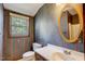 Cozy bathroom showcasing vintage wallpaper, a sink vanity and a toilet next to a window at 76 Traceway N, Sanford, NC 27332