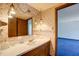 Bathroom featuring a vanity, a large mirror, and a doorway leading to another room at 76 Traceway N, Sanford, NC 27332