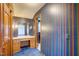 Hallway showcasing a vanity and ample storage, with unique striped wallpaper design at 76 Traceway N, Sanford, NC 27332