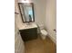 Modern bathroom with a single sink vanity, a framed mirror, and a toilet at 80 Valebrook Ct, Youngsville, NC 27596