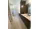 Modern bathroom with double vanities, tiled floors, and a glass-enclosed shower at 80 Valebrook Ct, Youngsville, NC 27596