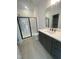 Modern bathroom featuring a glass-enclosed shower, tile floor, and sleek vanity at 80 Valebrook Ct, Youngsville, NC 27596