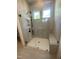 Updated bathroom features a glass enclosed shower with a built-in seat and tiled walls at 80 Valebrook Ct, Youngsville, NC 27596