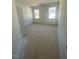 Bright bedroom featuring two large windows and a paneled door, ready for your personal touches at 80 Valebrook Ct, Youngsville, NC 27596