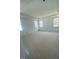 Bright bedroom with three windows and white walls offers a spacious and airy feel at 80 Valebrook Ct, Youngsville, NC 27596