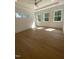 Bright bedroom with multiple windows allowing natural light and light hardwood floors at 80 Valebrook Ct, Youngsville, NC 27596