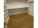 Bright walk-in closet with wooden floor and built-in shelves offering ample storage at 80 Valebrook Ct, Youngsville, NC 27596