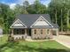 Charming single-Gathering home featuring stone accents, wooden shutters, attached garage and landscaped front yard at 80 Valebrook Ct, Youngsville, NC 27596
