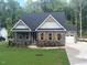 Charming single-Gathering home featuring a stone facade, a manicured lawn, and an attached two-car garage at 80 Valebrook Ct, Youngsville, NC 27596