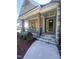 Inviting front porch featuring stone accents, wooden columns, and wrought iron railings at 80 Valebrook Ct, Youngsville, NC 27596
