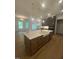 Open-concept kitchen with stainless steel appliances, a large island, and hardwood floors at 80 Valebrook Ct, Youngsville, NC 27596