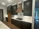 Beautiful kitchen with stainless steel appliances, granite countertops, and dark cabinetry at 80 Valebrook Ct, Youngsville, NC 27596