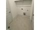 Well-lit laundry room with tile floor and convenient washer and dryer connections at 80 Valebrook Ct, Youngsville, NC 27596