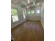 Well-lit office space featuring hardwood floors, wainscoting, and multiple windows at 80 Valebrook Ct, Youngsville, NC 27596