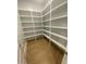 Well-organized walk-in pantry with white shelving providing ample storage space at 80 Valebrook Ct, Youngsville, NC 27596