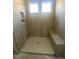 Shower featuring bench seating, tiled walls, and a shampoo niche at 80 Valebrook Ct, Youngsville, NC 27596