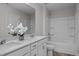 Bright bathroom featuring double sinks, white cabinets, and separate tub and shower at 82 Fairwinds Dr, Lillington, NC 27546