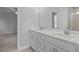 Bathroom showcasing double sinks, modern fixtures, and a view into the Primary bedroom at 82 Fairwinds Dr, Lillington, NC 27546