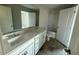 Modern bathroom with double sink vanity, a large mirror, and a separate shower and toilet area, tiled floors at 82 Fairwinds Dr, Lillington, NC 27546