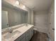 Bathroom featuring double sinks, a large mirror, and a shower-tub combo at 82 Fairwinds Dr, Lillington, NC 27546