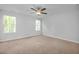 Bright bedroom with plush carpeting, fan, and windows offering natural light at 82 Fairwinds Dr, Lillington, NC 27546