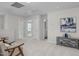 Light filled bonus room with two chairs, table and stylish painting at 82 Fairwinds Dr, Lillington, NC 27546