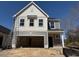 New construction two-story home with gray and white siding, featuring an attached two-car garage at 82 Fairwinds Dr, Lillington, NC 27546
